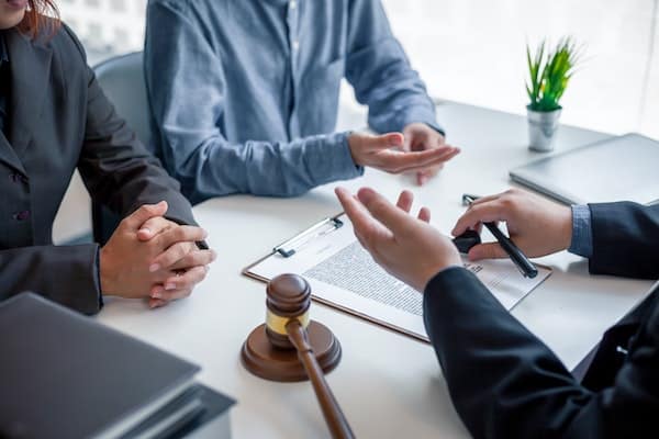 Lawyers talking to insurance adjusters