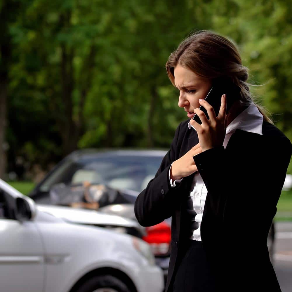 Woman calling lawyer after getting into car accident